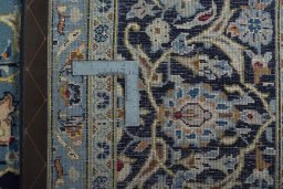 Backside of handmade 2000s Kashan rug showing knot structure and weave density