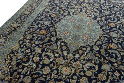 Backside of handmade 2000s Kashan rug showing knot structure and weave density