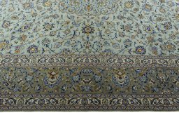 Corner detail of 2000s Kashan rug showing border pattern and Wool pile