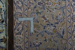 Backside of handmade 2000s Kashan rug showing knot structure and weave density