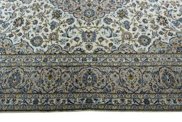 Corner detail of 2000s Kashan rug showing border pattern and Wool pile