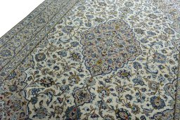 Backside of handmade 2000s Kashan rug showing knot structure and weave density