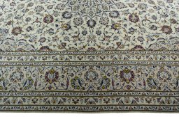Corner detail of 2000s Kashan rug showing border pattern and Wool pile
