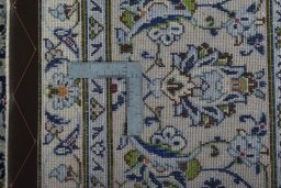Backside of handmade 2000s Kashan rug showing knot structure and weave density