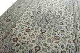 Backside of handmade 2000s Kashan rug showing knot structure and weave density