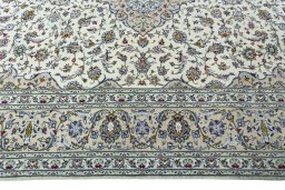 Corner detail of 2000s Kashan rug showing border pattern and Wool pile