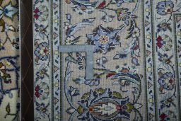 Backside of handmade 2000s Kashan rug showing knot structure and weave density