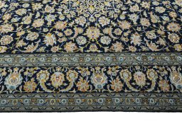 Corner detail of 2000s Kashan rug showing border pattern and Wool pile