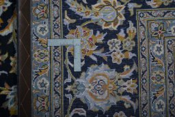Backside of handmade 2000s Kashan rug showing knot structure and weave density