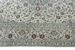 Corner detail of 2000s Kashan rug showing border pattern and Wool pile