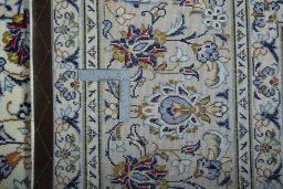 Backside of handmade 2000s Kashan rug showing knot structure and weave density