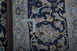 Backside of handmade 2000s Kashan rug showing knot structure and weave density