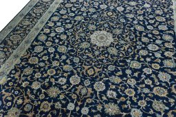 Backside of handmade 2000s Kashan rug showing knot structure and weave density