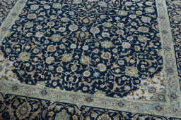Close-up detail of 2000s Kashan rug from Iran / Persia showing Wool weave