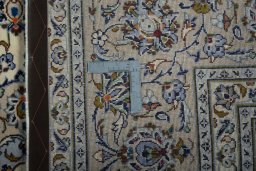 Backside of handmade 2000s Kashan rug showing knot structure and weave density