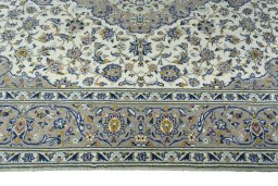 Corner detail of 2000s Kashan rug showing border pattern and Wool pile