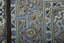 Backside of handmade 2000s Kashan rug showing knot structure and weave density