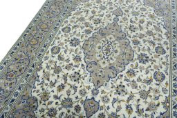 Backside of handmade 2000s Kashan rug showing knot structure and weave density