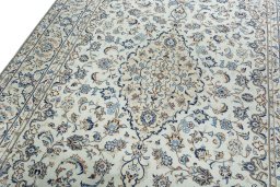 Backside of handmade 2000s Kashan rug showing knot structure and weave density