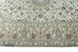 Corner detail of 2000s Kashan rug showing border pattern and Wool pile