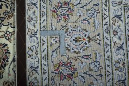Backside of handmade 2000s Kashan rug showing knot structure and weave density