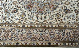 Corner detail of 2000s Kashan rug showing border pattern and Wool pile