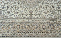 Corner detail of 2000s Kashan rug showing border pattern and Wool pile