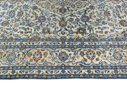 Corner detail of 2000s Kashan rug showing border pattern and Wool pile