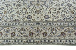 Corner detail of 2000s Kashan rug showing border pattern and Wool pile