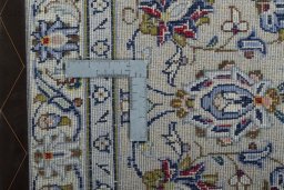 Backside of handmade 2000s Kashan rug showing knot structure and weave density