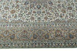 Corner detail of 2000s Kashan rug showing border pattern and Wool pile