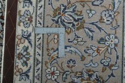 Backside of handmade 2000s Kashan rug showing knot structure and weave density