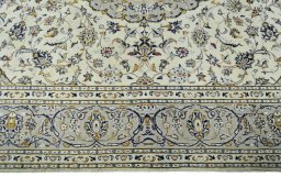 Corner detail of 2000s Kashan rug showing border pattern and Wool pile
