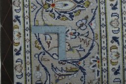 Backside of handmade 2000s Kashan rug showing knot structure and weave density