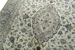 Backside of handmade 2000s Kashan rug showing knot structure and weave density