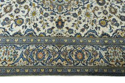 Corner detail of 2000s Kashan rug showing border pattern and Wool pile