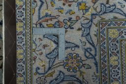 Backside of handmade 2000s Kashan rug showing knot structure and weave density