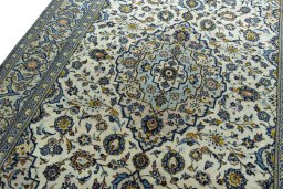 Backside of handmade 2000s Kashan rug showing knot structure and weave density
