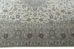 Corner detail of 2000s Kashan rug showing border pattern and Wool pile