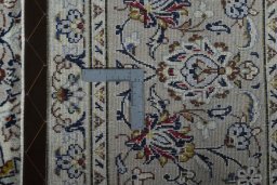 Backside of handmade 2000s Kashan rug showing knot structure and weave density