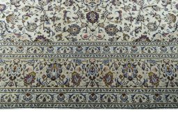 Corner detail of 2000s Kashan rug showing border pattern and Wool pile