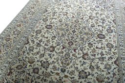 Backside of handmade 2000s Kashan rug showing knot structure and weave density