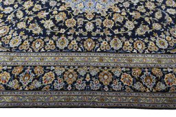 Corner detail of 2000s Kashan rug showing border pattern and Wool pile