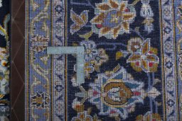 Backside of handmade 2000s Kashan rug showing knot structure and weave density