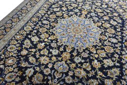 Backside of handmade 2000s Kashan rug showing knot structure and weave density