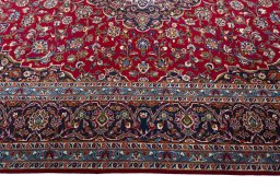 Corner detail of 2000s Kashan rug showing border pattern and Wool pile