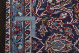 Backside of handmade 2000s Kashan rug showing knot structure and weave density