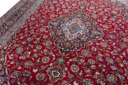 Backside of handmade 2000s Kashan rug showing knot structure and weave density