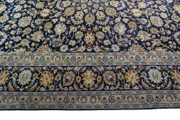 Corner detail of 2000s Kashan rug showing border pattern and Wool pile