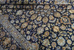 Close-up detail of 2000s Kashan rug from Iran / Persia showing Wool weave